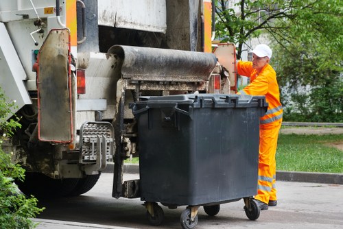 Operatives wearing PPE during rubbish removal in an apartment building